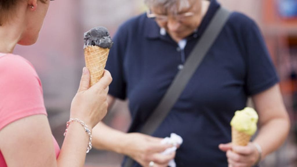 Naiset syövät jäätelöä Kauppatorilla Helsingissä 12. heinäkuuta 2012.