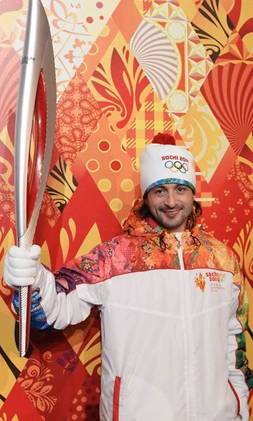 Venäjän taitoluistelija Ilia Averbukh olympiasoihdun kanssa.