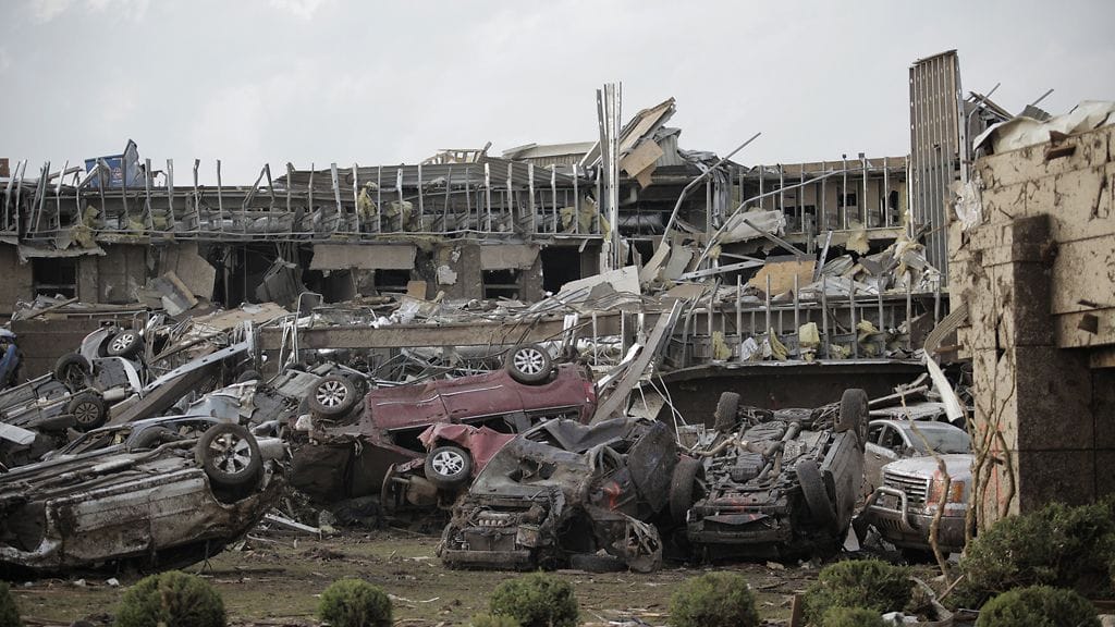 Flipped vehicles are piled up outside the heavily damaged Moore Medical Center after a powerful tornado ripped through the area on May 20, 2013 in Moore, Oklahoma.
