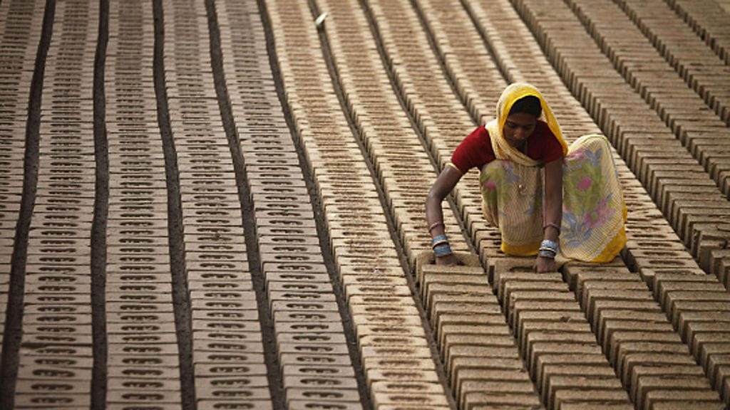 An Indian woman works at a brick factory on the outskirts of Jammu, India,Thursday March 8, 2012. International Women's Day is being marked Thursday. (AP Photo/Channi Anand)