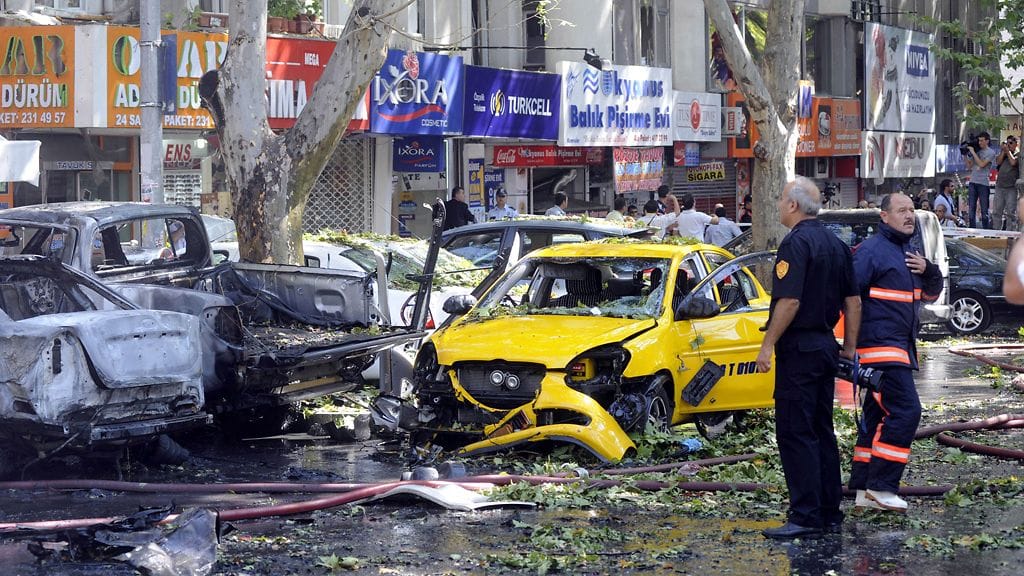 Turkish firemen and police officers search the area after a blast in Ankara, Turkey on 20 September 2011.
