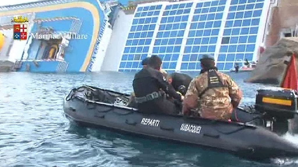 Sukeltajat tutkivat Costa Concordia -risteilijää. Kuva: APTN