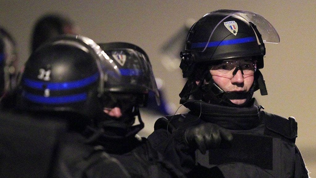 Poliisin erikoisjoukot epäillyn asunnon edessä.