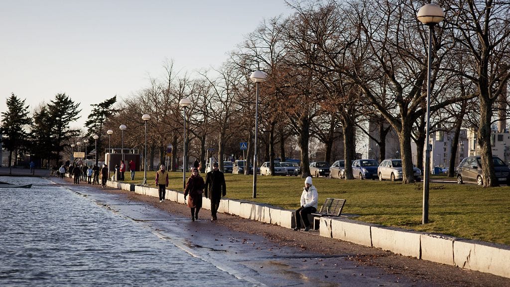 Ulkoilijoita Kaivopuiston rannassa Helsingissä tapaninpäivänä 26. joulukuuta 2011. Merivesi on noussut rannassa korkealle.