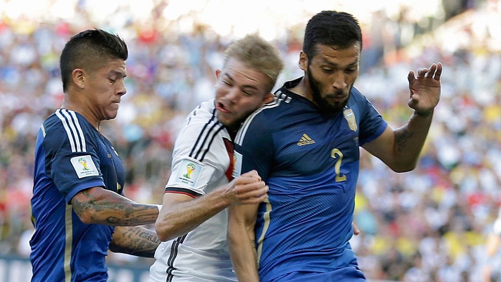 Christoph Kramer törmää Ezequiel Garayn olkapäähän MM-finaalissa.