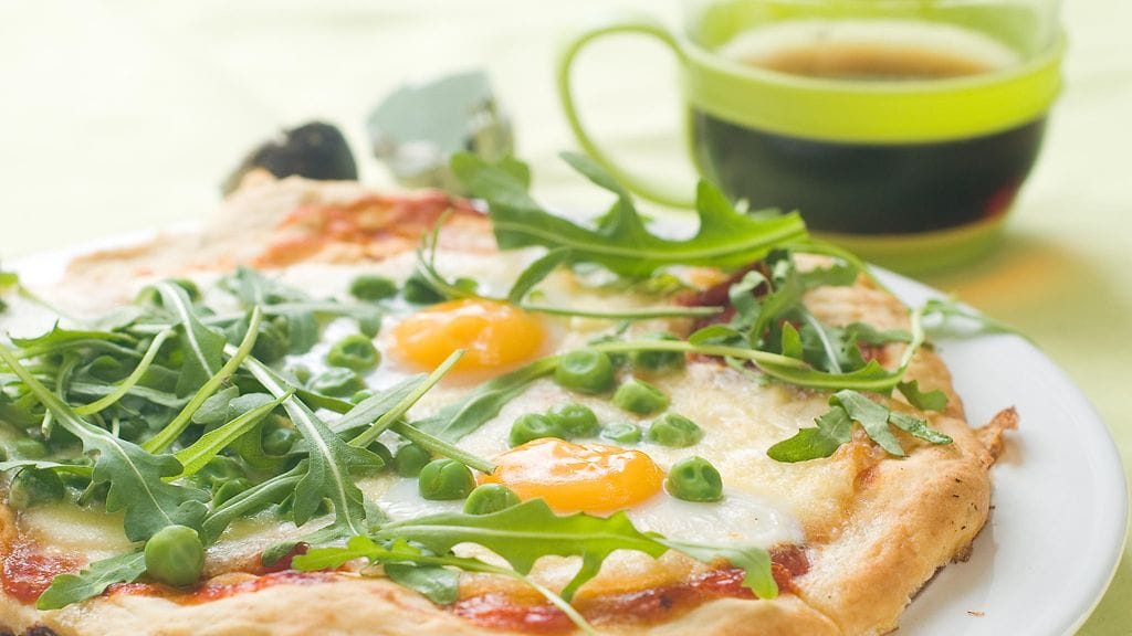 Tässä aamiaispizzassa täytteenä on rucolaa ja kananmunaa.