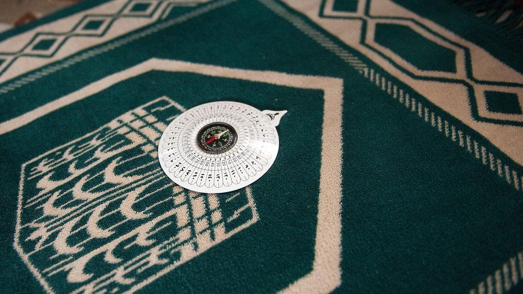 Rukousmatto ja kompassi. Kuvituskuva.