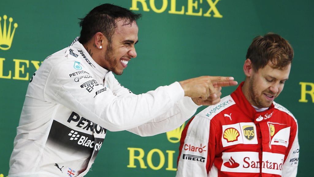 Tuttu näky viime kaudelta: Mersun Lewis Hamilton juhlii, Ferrarin Sebastian Vettel on tyytyminen kolmanteen sijaan.