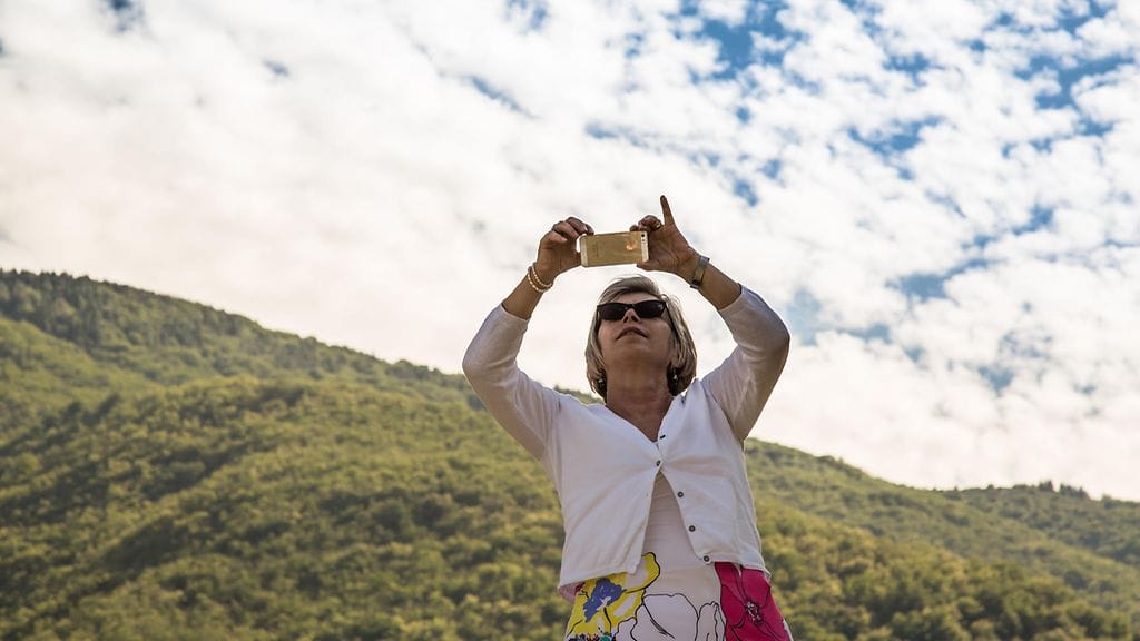 Matkailijat ympäri maailman myöntävät olevansa riippuvaisia mobiililaitteistaan – myös lomalla. Kuvituskuva.