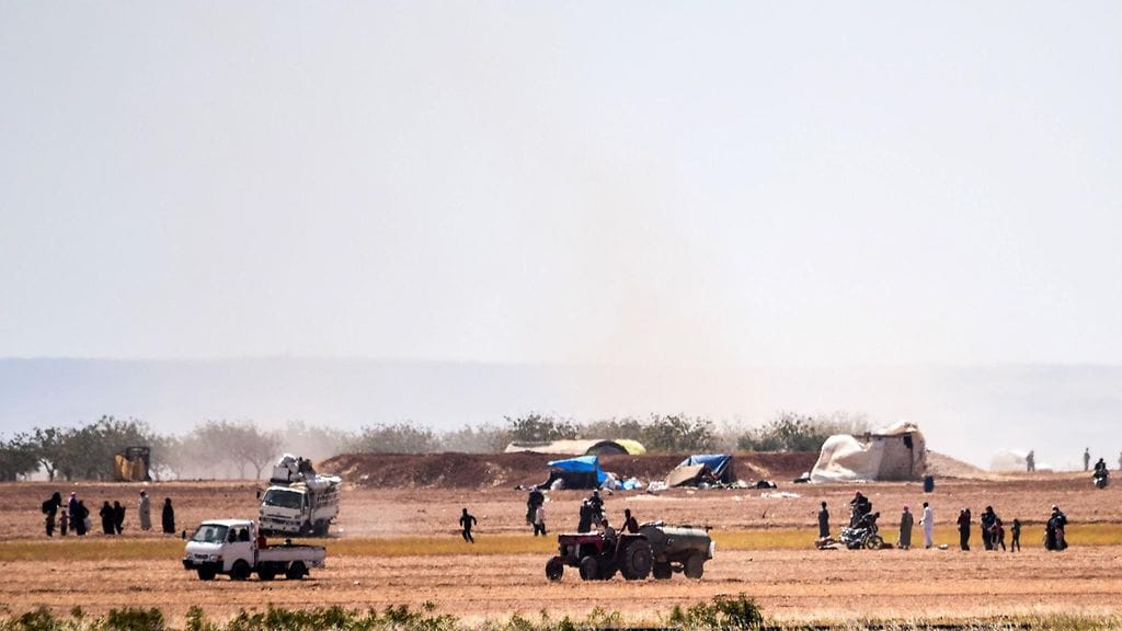 Siviilit pakenivat Turkin armeijan ja ISIS:in yhteenottoja 20 kilometriä länteen Turkin rajalta Karkamisin kaupungissa.  / AFP / BULENT KILIC - LEHTIKUVA / AFP