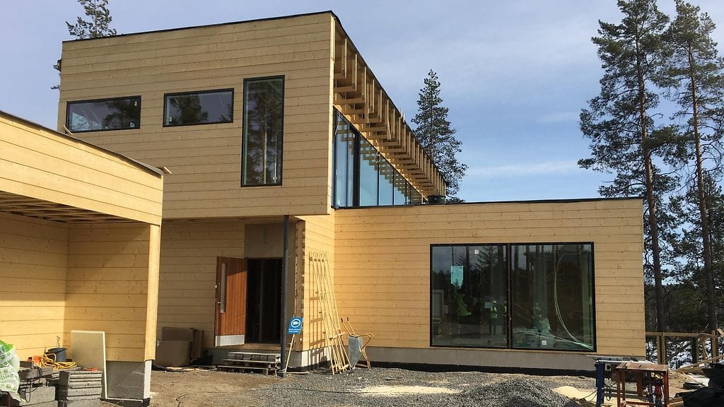 Villa Saimaanhelmen sisäänkäynti. Alakerran suuri ikkuna kätkee taakseen vieras- ja työhuoneen. Katolle tulee toinen kodin suurista terasseista.