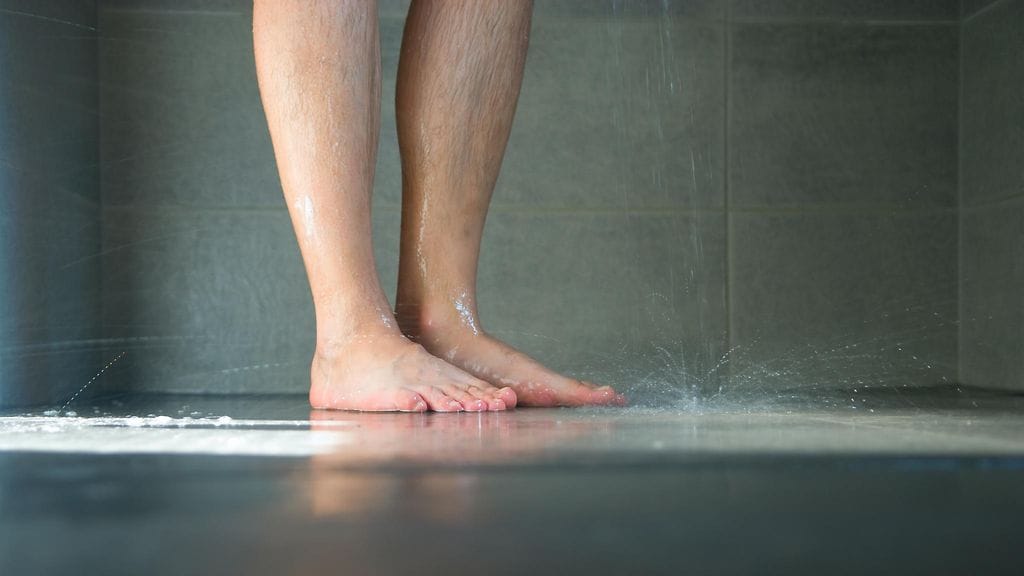 Mies testasi, kannattaako suihkun hana kääntää lämpimän sijaan kylmälle.