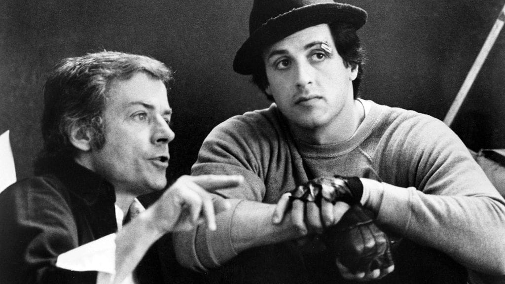 Ohjaaja John G. Avildsen ja nuori Sylvester Stallone Rocky-elokuvan kuvauksissa vuonna 1976.