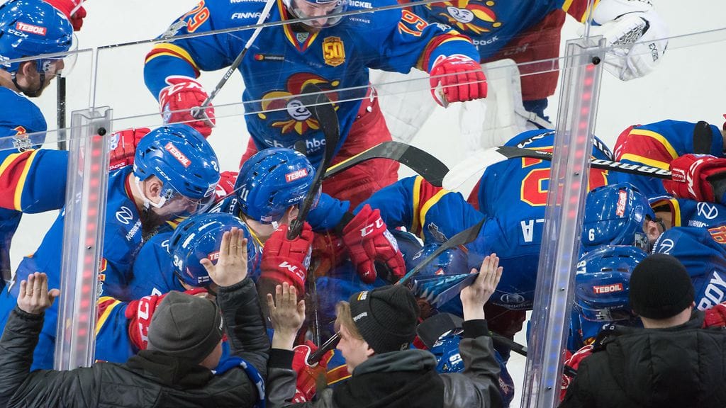 Jokereiden joukkue tuulettamassa Eeli Tolvasen yllä viidennen Sotshi-pelin jälkeen.