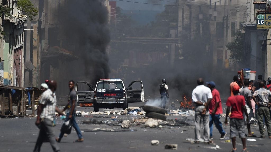 Poliisi vartioi Haitin pääkaupungissa Port-au-Princessa levottomuuksia, jotka alkoivat polttoaineen hinnankorotuksista. Kuva otettu 9.7.2018.