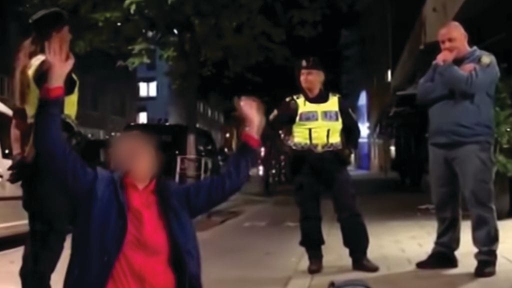 Kuvankaappaus verkkoon levinneestä videosta, jossa kiinalaisperhe protestoi kohteluaan kadulla hostellin edustalla.