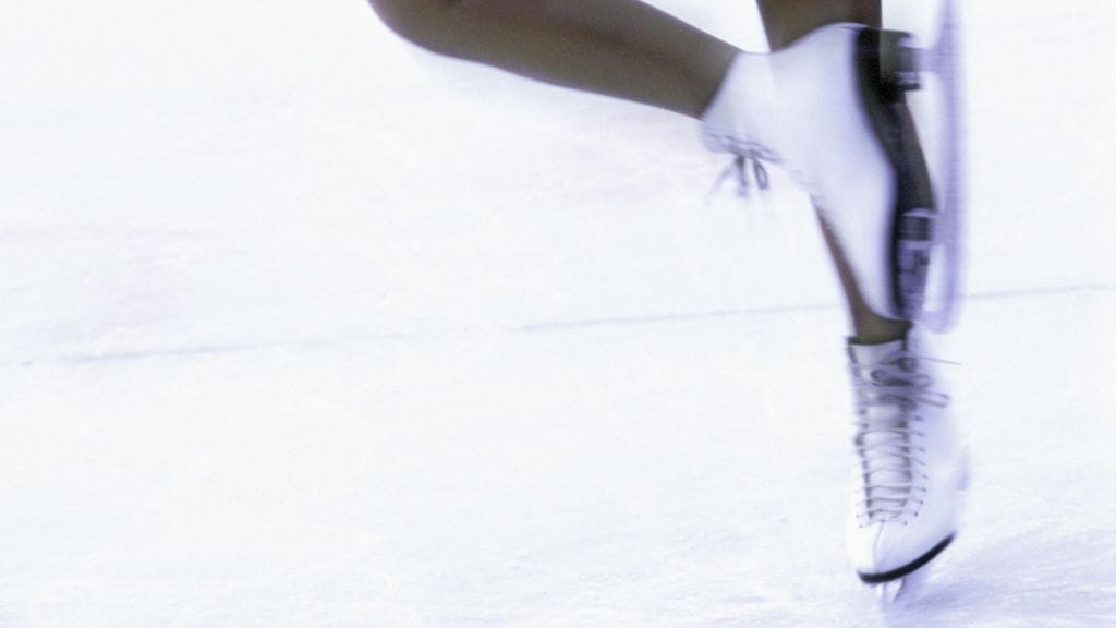 Kuvituskuva taitoluistelijasta.