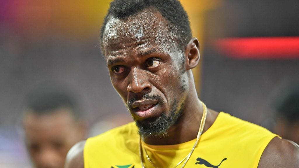 Usain Bolt opastaa Sha'Carri Richardsonia.