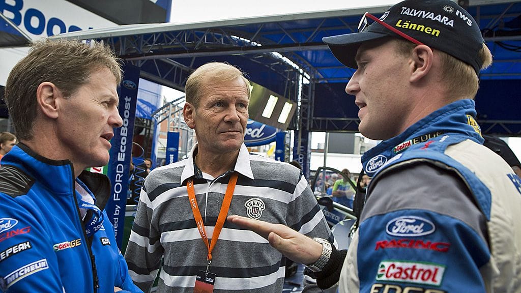 Malcolm Wilson, Juha Kankkunen ja Jari-Matti Latvala keskustelemassa huoltoparkissa.