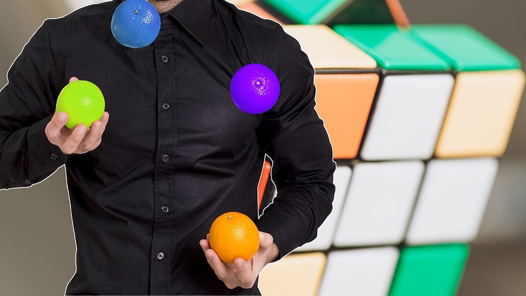 Selvittäisitkö Rubikin kuution samalla, kun jonglööraat? Kuvituskuva.