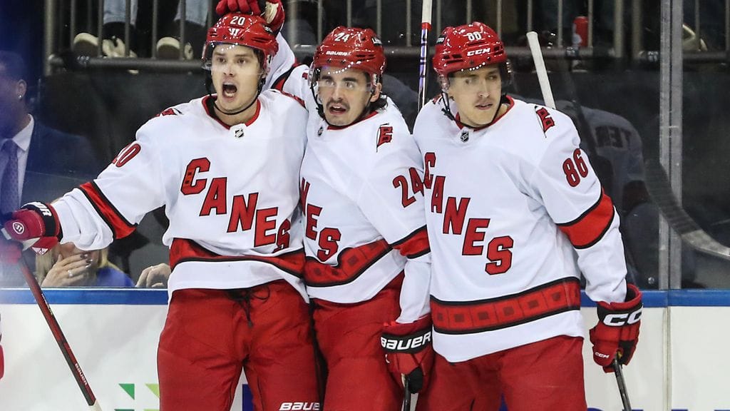 Suomalaispelaajien seurassa paljon aikaa viettänyt Carolina Hurricanesin kanadalaishyökkääjä Seth Jarvis (keskellä) on oppinut suomea. Kuvassa hän juhlii maalia Sebastian Ahon ja Teuvo Teräväisen kanssa.