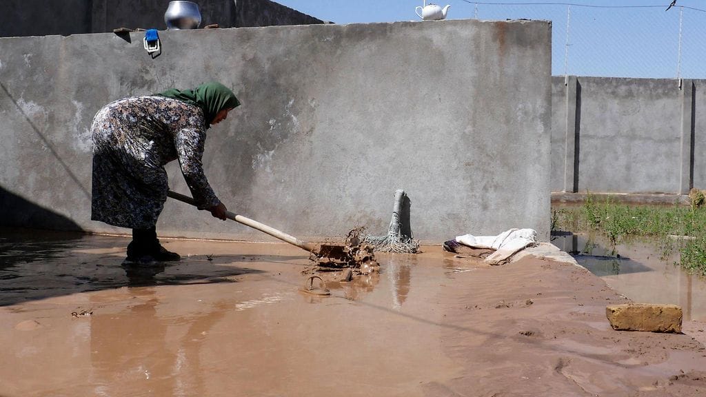 Afgaaninainen selvitti tulvatuhoja kotipihallaan.