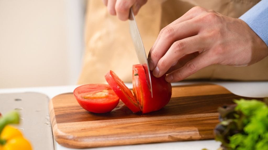 tomaattia leikkaamassa