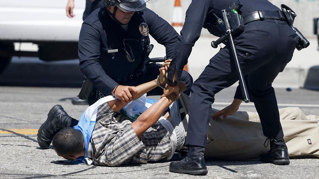Los Angeles police officers arrest a person during protests near the Edward R. Roybal Federal Building in Los Angeles, California, USA, 08 June 2025.