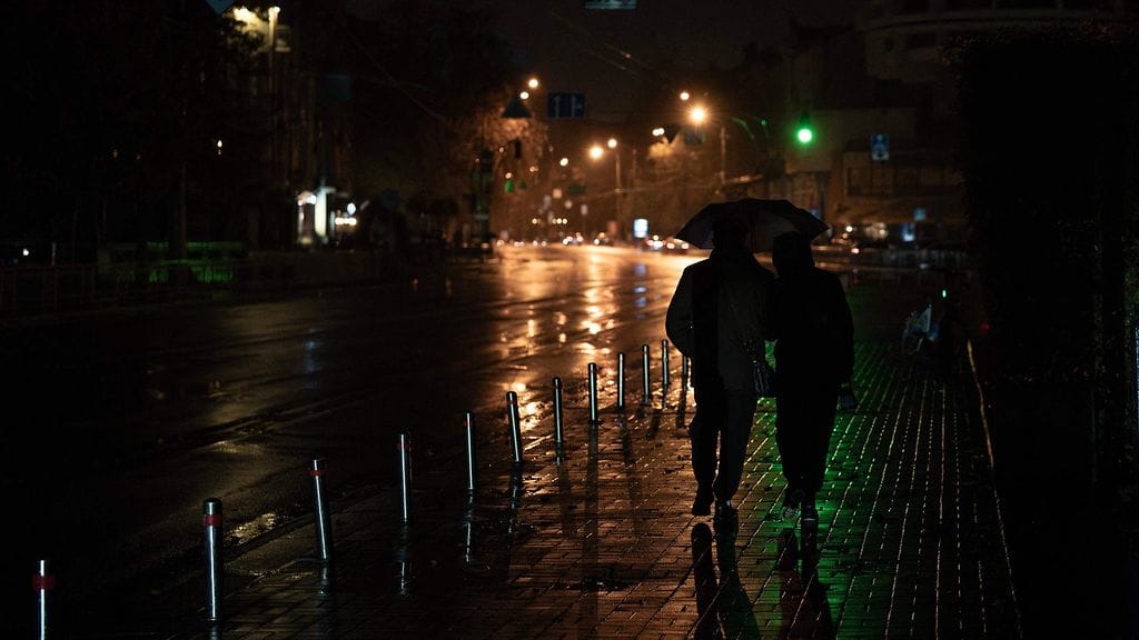 LK 13.10.2025 Ihmisiä kadulla sateenvarjojen alla sähkökatkon aikana Kiovassa 10. lokakuuta 2025.