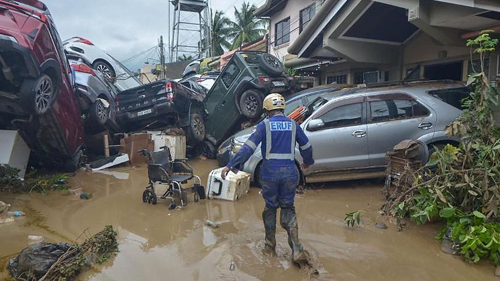 Pelastustyöntekijä kahlasi vedessä Cebun saarella Filippiineillä 4. marraskuuta 2025.