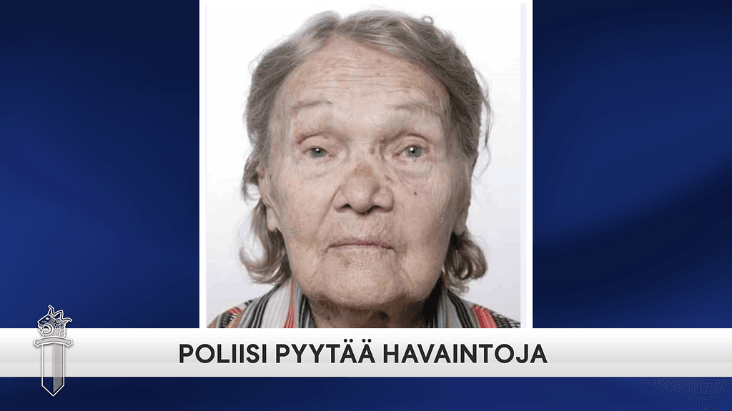 Kuvassa esiintyvä nainen on pienikokoinen, noin 150 cm pitkä. Hänellä on yllään valkoinen pipo ja tumma päällystakki.